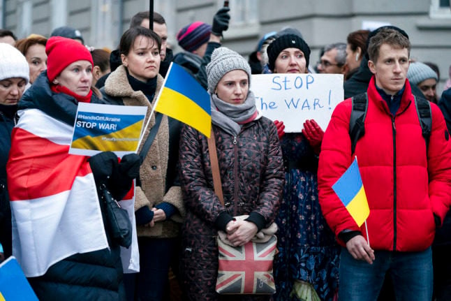 People in Copenhagen protest at the Russian Embassy