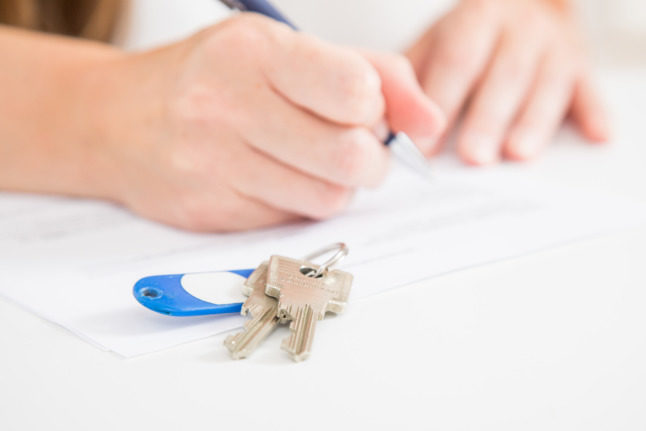 A new tenant signs their rental agreement.