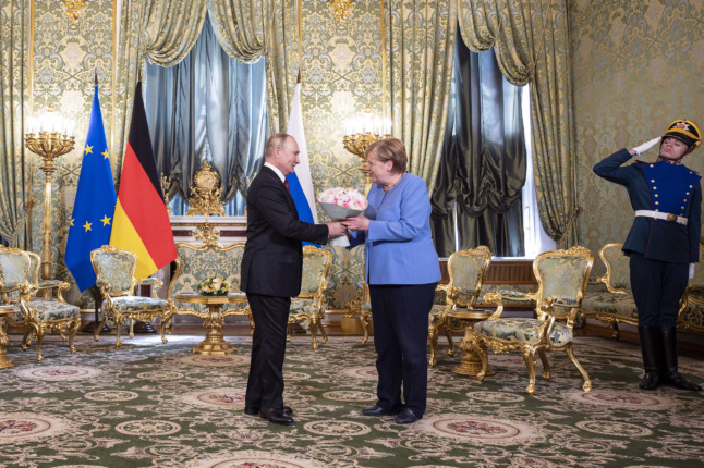 Vladimir Putin and Angela Merkel