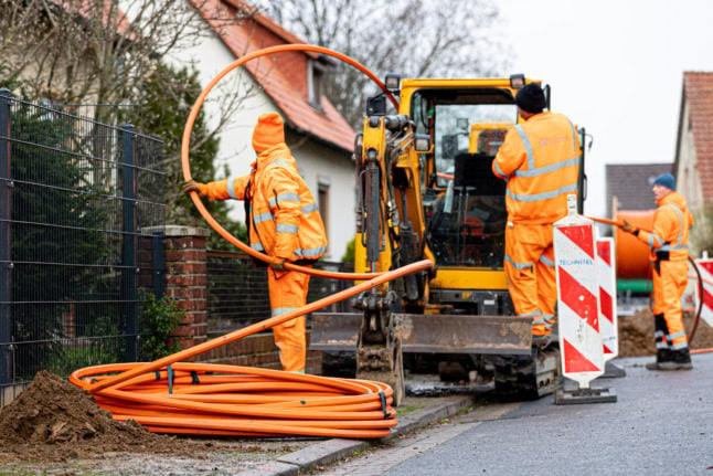 Construction workers lay cables in Schulenberg, Lower Saxony