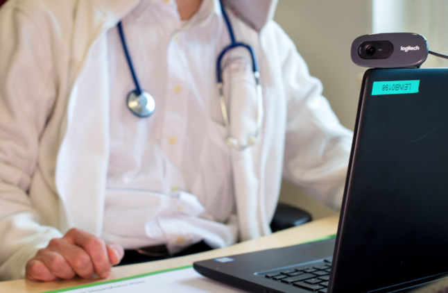 A German doctor taking part in a video consultation.