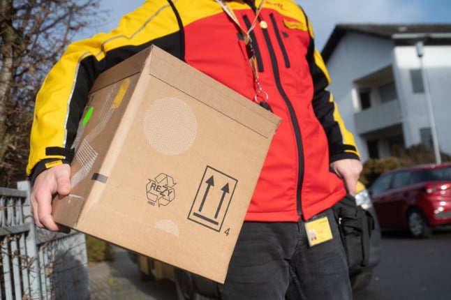 A DHL employee delivering a packet in Germany.