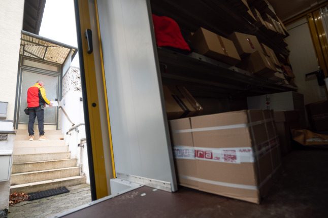 A DHL worker carrying out deliveries.