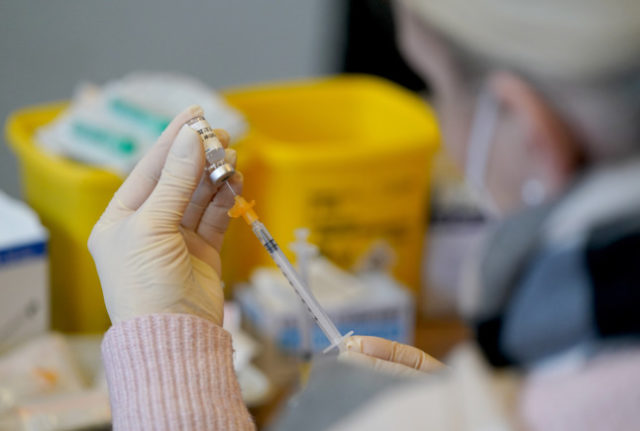 A health worker prepares a dose of Covid vaccine