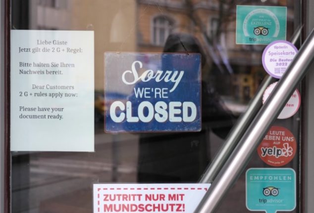 A restaurant in Berlin with a sign telling customers about the 2G-plus rules.