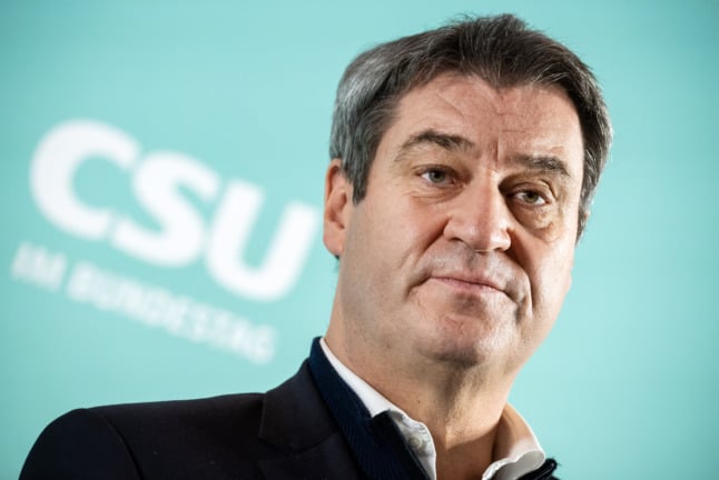 Bavaria's premier Markus Söder peaks at a meeting of the CSU parliamentary group. 