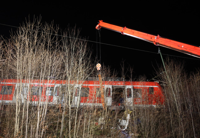 A crane is in use at the scene of the accident.