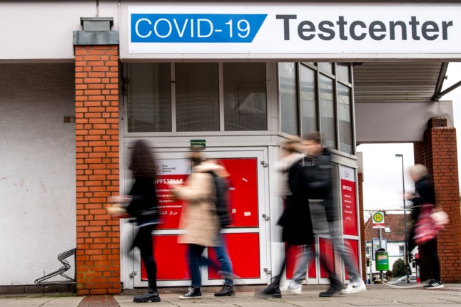 People walk past a Covid test centre in Bremen.