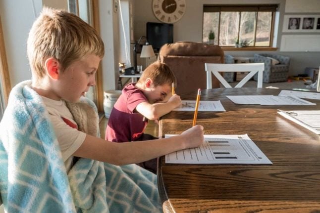 Children work through their studies at home