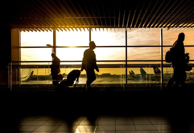 Passengers travel through a German airport.