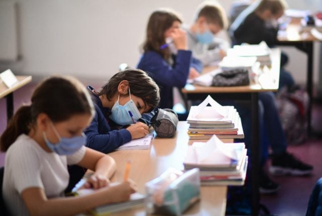 Children wear facemasks during lessons in school