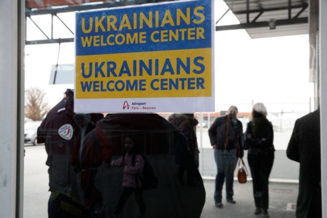 A sign at the Paris-Beauvais Airport indicates a welcome centre for Ukrainian nationals fleeing conflict. The French government has published guidance on what steps they should take once in France.