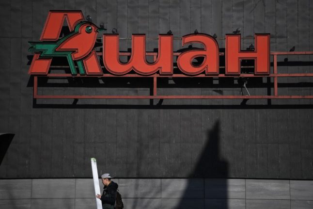 The logo of French retailer Auchan is pictured on a shopping centre in Moscow.