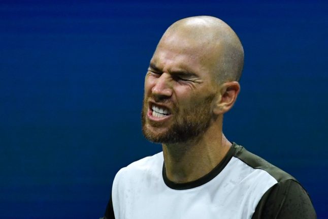 French tennis player, Adrian Mannarino, reacts angrily on the court.