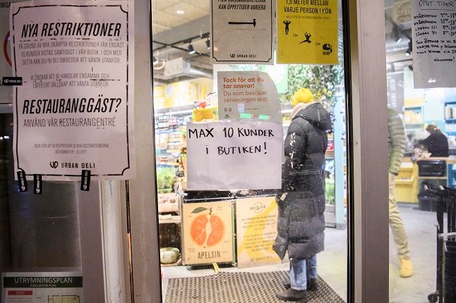 A sign tells visitors to a Stockholm supermarket that a maximum of ten shoppers are allowed at a time under the pandemic law.