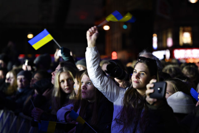 People waving Ukrainian flags at a support concert for Ukraine at Rådhuspladsen on Saturday 12 March 2022.