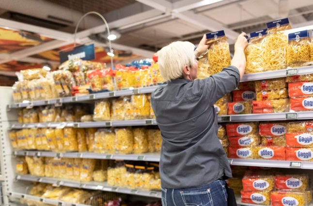 A supermarket employee in Offenburg stocks pasta in 2020. Pasta has been increasing in price in Germany. 