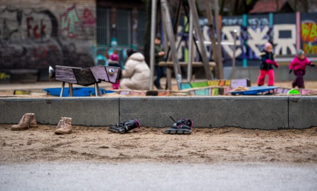 Children and families at a playground in Berlin.