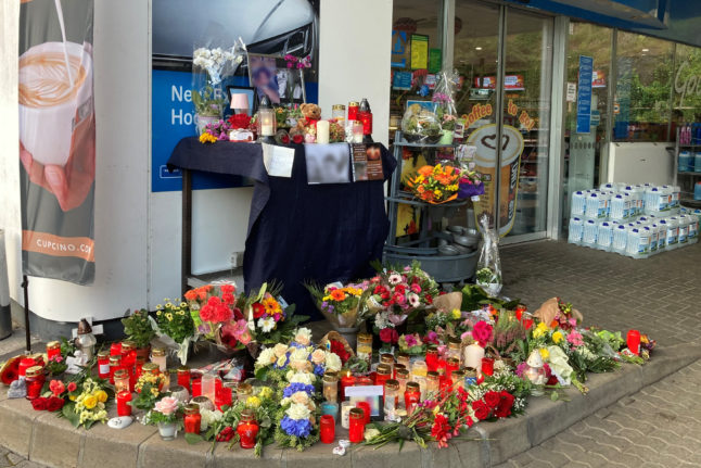 Flowers and tributes at the site where a man was killed while working in a petrol station in Idar-Oberstein.