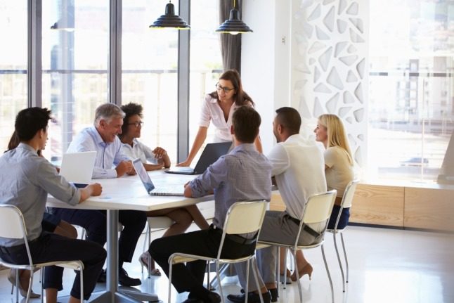 People sit around a table at work.