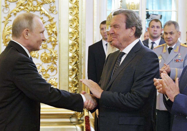 Russian President Vladimir Putin greets ex German Chancellor Gerhard Schröder in May 2018 during a ceremony marking Putin’s inauguration.
