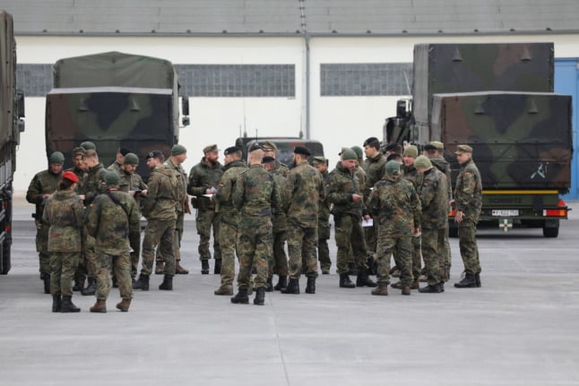Bundeswehr soldiers gather at a training area before travelling to Lithuania for a NATO mission in February 2022. 