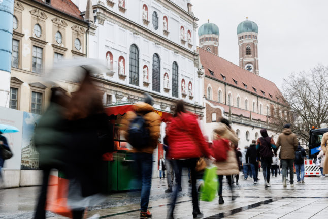 Passers-by walk through Kaufingerstraße in Munich's city centre.