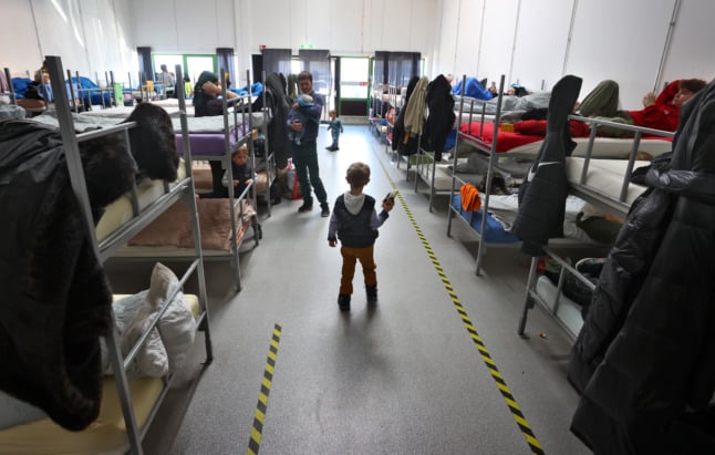 A young boy from Ukraine holds a toy in a refugee reception centre in Augsburg.