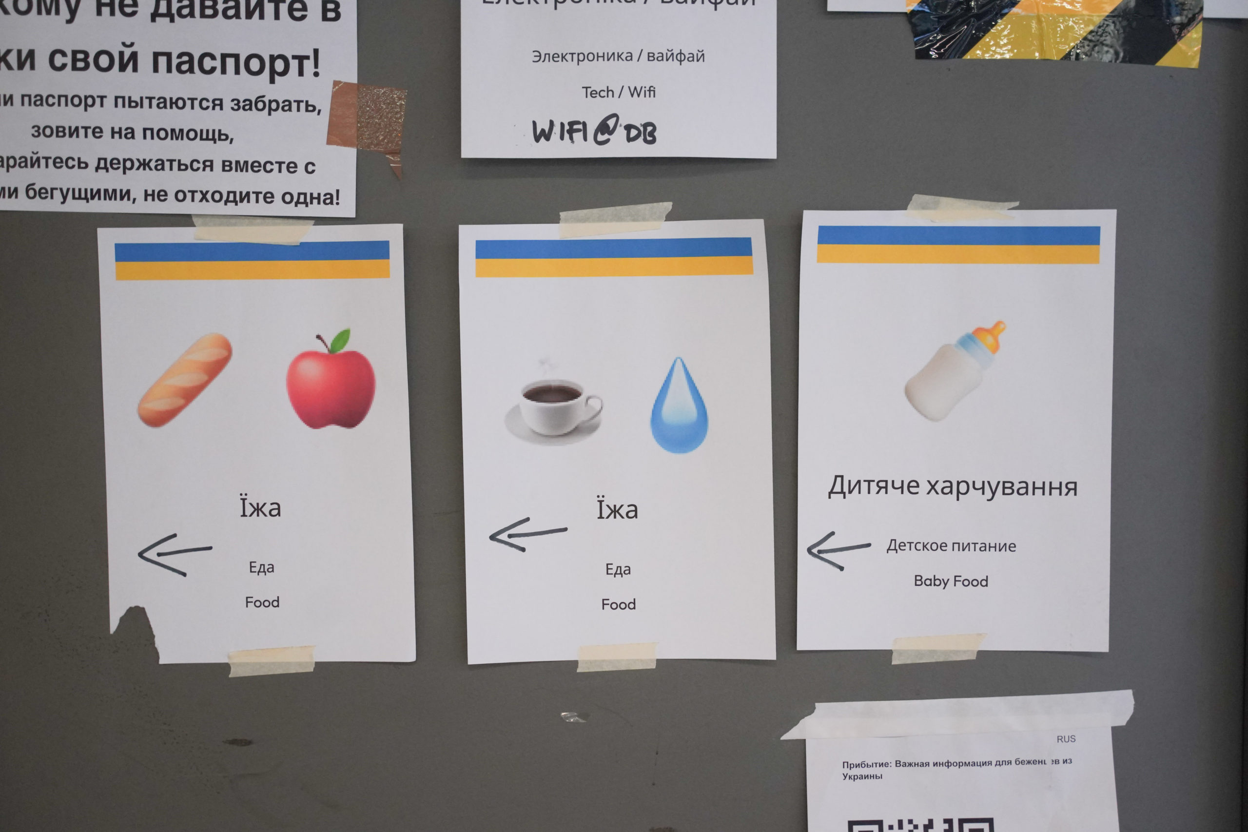 Signs directing refugees from Ukraine to supplies in Berlin main station. 