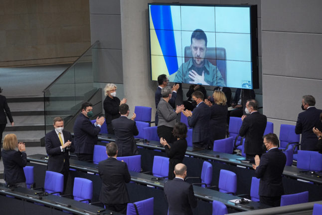 Ukrainian President Volodymyr Zelensky speaks via a video link in the Bundestag and receives a standing ovation.