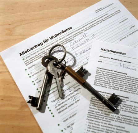 A set of keys placed on a rental contract in Germany.