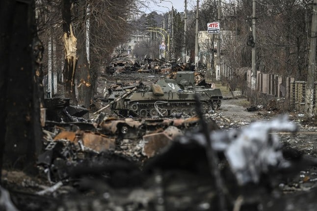 A column of destroyed Russian armoured vehicles sits abandoned in the city of Bucha, west of Kyiv