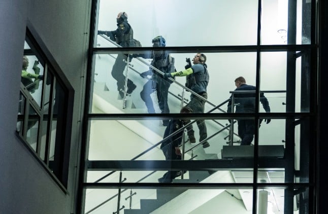 Officers from the Swedish police's National Task Force search buildings at the school after the attack.