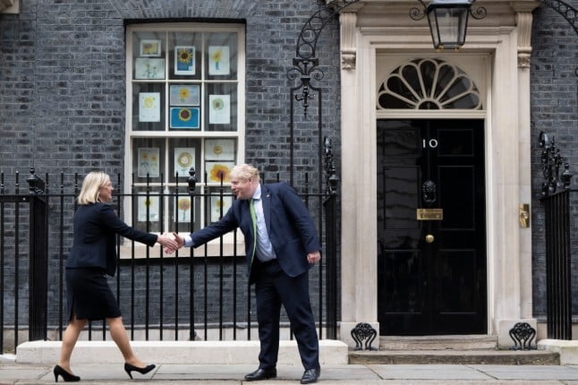 Swedish Prime Minister Magdalena Andersson shakes hands with UK Prime Minister Boris Johnson outside 10, Downing Street.