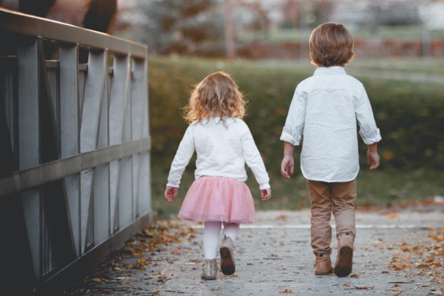 little girl and little boy walking together