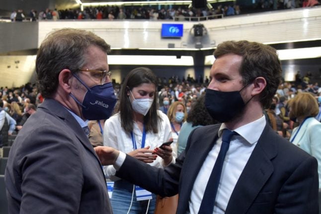 Alberto Nunez Feijoo (L) and outgoing Popular Party leader Pablo Casado react at the end of the 20th National Congress of the Popular Party (PP) at the Fibes conference and exhibition centre in Seville on April 1, 2022. 