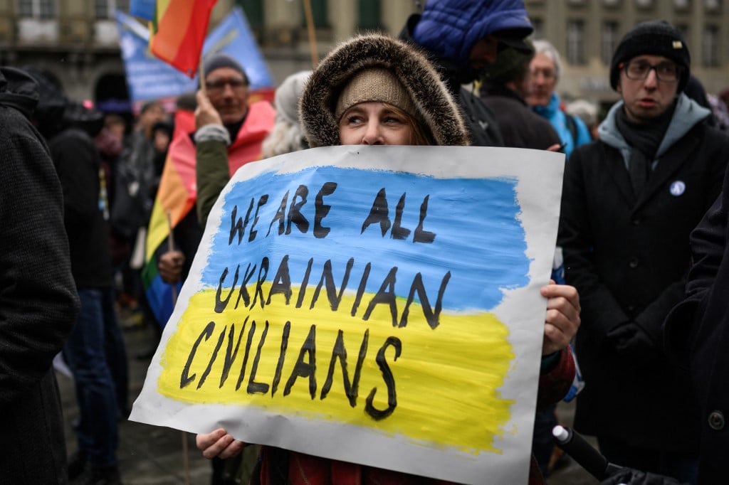 A woman holds a placard during a national demonstration in Bern against the war in Ukraine.