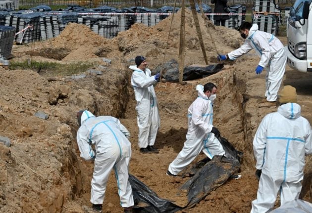 French forensic experts exhume bodies from a mass grave in Bucha, north-west of Kyiv