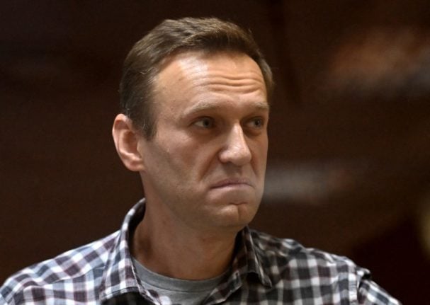 Russian opposition leader Alexei Navalny inside a glass cell during a court hearing