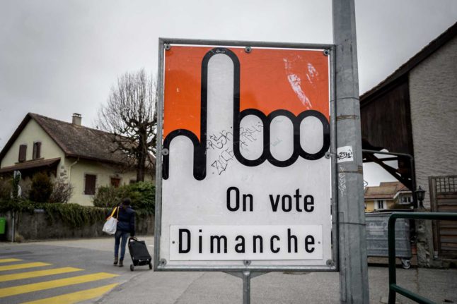A sign in the western Swiss canton of Vaud reminding people of a referendum on Sunday. Photo: Fabrice COFFRINI / AFP