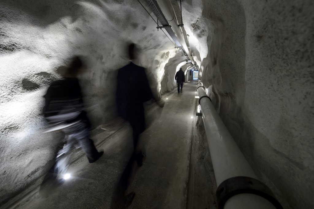 People walk in a corridor of the Deltalis Swiss Mountain Data Center, a former Swiss Army bunker