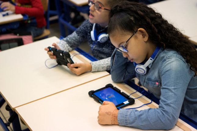 Schoolchildren in France learn how to verify fake news sources online.