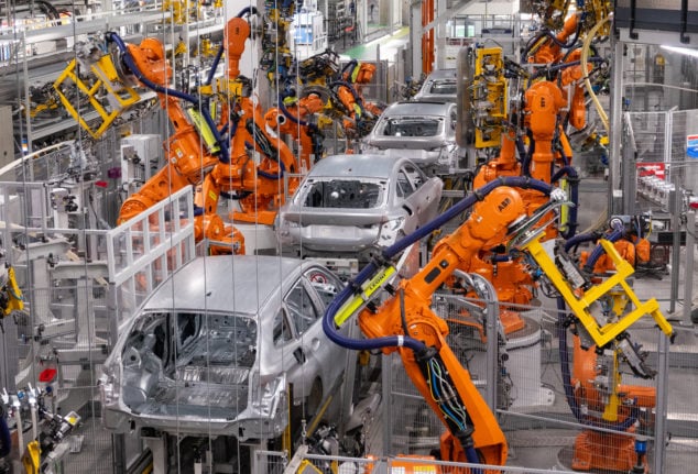 Robots working on the bodywork of various car models.