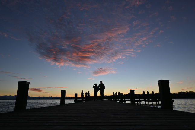 Two people enjoy the view at the Starnberger See in Bavaria.