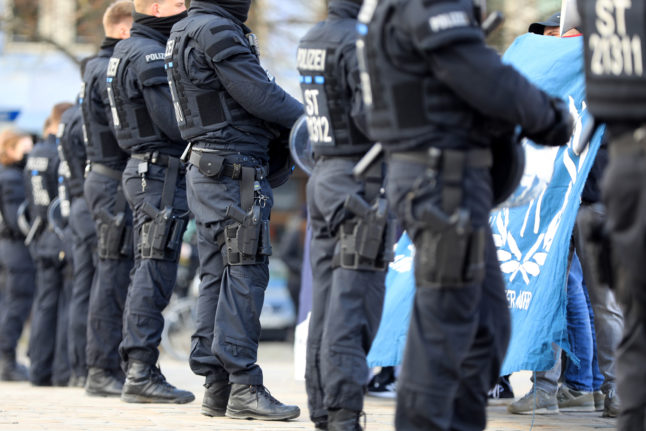 Police officers guard several demonstrations on Domplatz square in the Berlin.