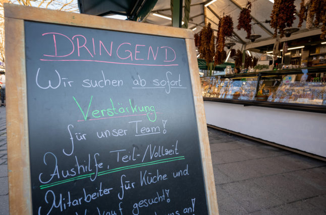 A board outside a Munich cafe advertises a job vacancy