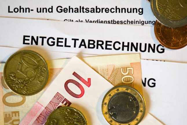 Money lies on top of a German payslip.