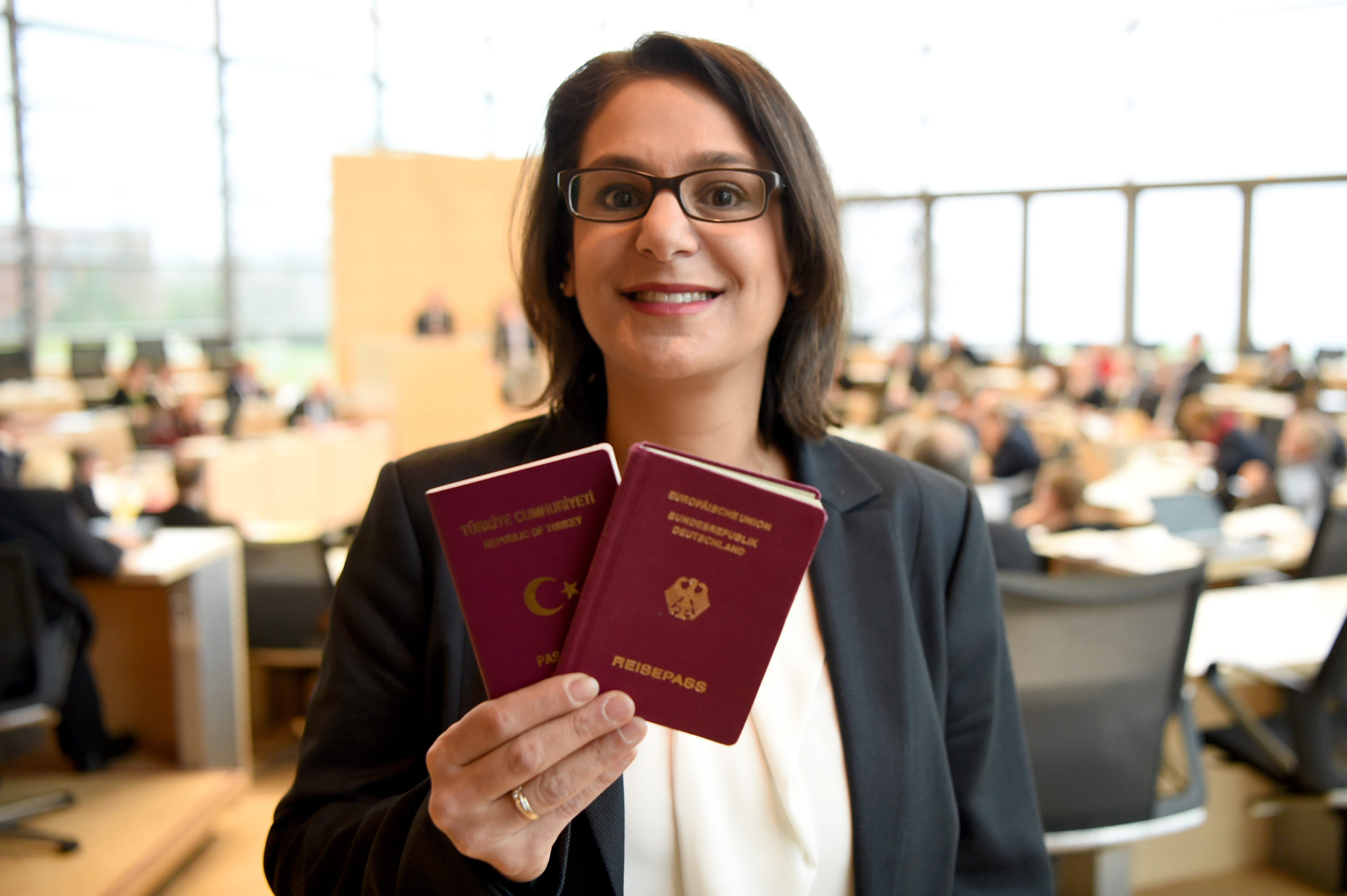 SPD politician Serpil Midyatli displays her Turkish and German passports