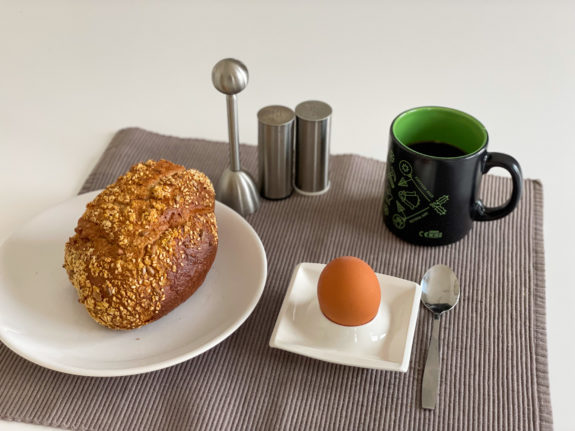 Austrian breakfast with bread, boiled eggs and coffee