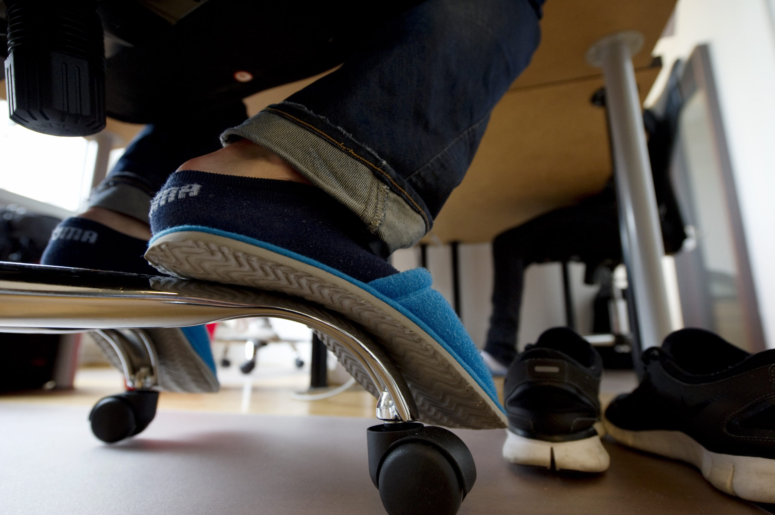 An employee of an internet startup wears slippers while working in Berlin.